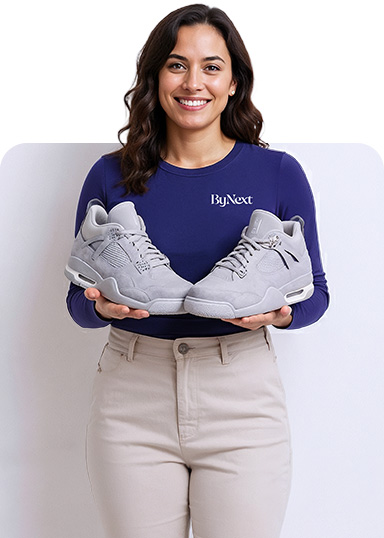 Woman Holding Professionally Cleaned Luxury Sneakers Ready for Delivery by ByNext